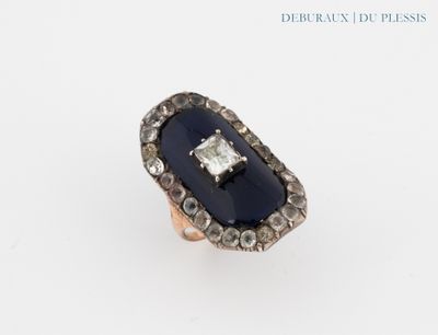 a close up of a ring on a white surface with diamonds