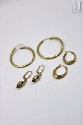 three pairs of gold hoop earrings and a pair of gold hoop earrings