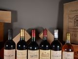 several bottles of wine are lined up in a row on a table