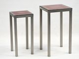 pair of metal and glass side tables on a white background