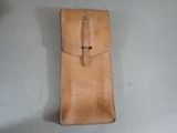 tan leather case for a lighter and lighter lighter on a table