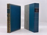 two blue books sitting side by side on a white surface