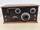 an old fashioned radio sitting on top of a wooden table
