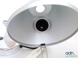 a lamp that is sitting on a table with a tag attached to it