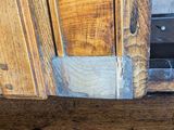 a close up of a wood floor with a piece of wood sticking out of it