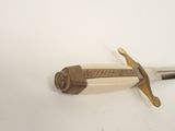 a knife that is laying on a white surface