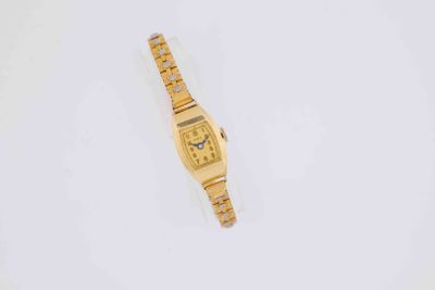 an image of a gold wrist watch on a white surface