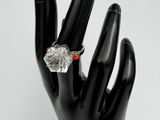 black mannequin hand with a diamond ring on it ' s finger