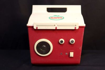 a small red and white cooler with two eyes on it