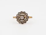 an antique diamond cluster ring in yellow gold and white diamonds