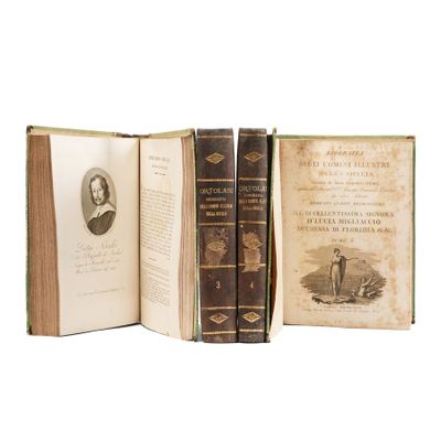 three old books are stacked on top of each other on a white surface