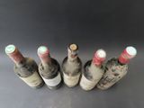 several bottles of wine are lined up on a table