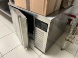 boxes are stacked on top of a microwave oven in a kitchen