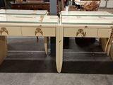 two tables with glass tops in the middle of a room
