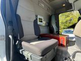 a seat in the back of a van with a suitcase in it