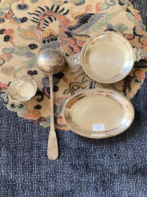 three silver dishes and spoons on a rug