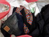 a suitcase full of clothes and a hat on the bed