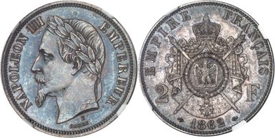 a close up of a silver coin with a crown on it