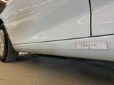 a close up of a white car with a sticker on it