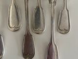 five spoons and two spoon spoons on the table