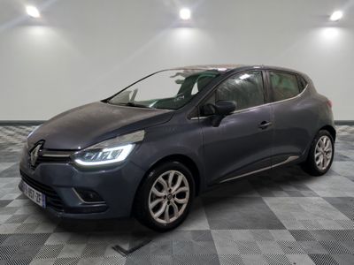 a grey car is parked in a room with a checkered floor