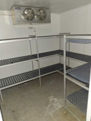 a room with bunk beds and a fan in it