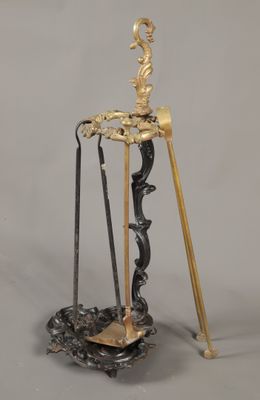 une figurine en or et en argent posée sur un socle, accompagnée de deux balais