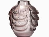 a glass vase that is sitting on a white surface