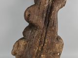 an old wooden sculpture of a bear holding a piece of wood