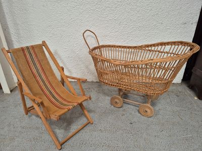 two wicker chairs and a baby stroller next to each other