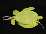 a yellow turtle shaped purse with a keychain on it