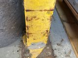 a yellow fire hydrant that has eyes on it