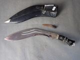 a knife that is laying on the ground next to a knife