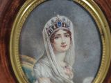 portrait of a woman wearing a tiara and a veil in a wooden frame