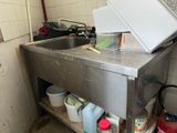 a kitchen with a sink and a microwave on the counter