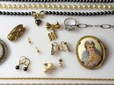 many different necklaces and bracelets on a table