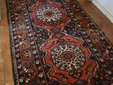 a rug on the floor in a room with wood floors