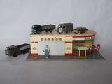 a toy garage with cars and a train on it