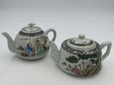 pair of chinese porcelain teapots with figures on them