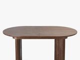 an oval dining table with wooden legs and a wooden top
