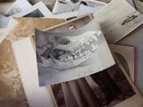a pile of old photos of a man and a woman