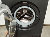 a washing machine sitting on a pallet next to a washing machine