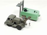 a green toy truck with a crane attached to it ' s back