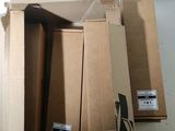 three cardboard boxes stacked on top of each other in a room