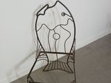 a metal chair that is sitting in a room