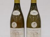 two bottles of wine sitting next to each other on a table