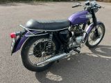 a purple motorcycle that is parked in a parking lot