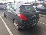 a small black car parked in a parking lot