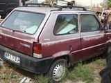 a red car that is parked in the grass