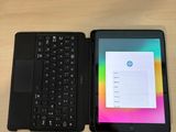 a tablet with a keyboard next to a laptop on a table